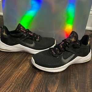 Nike womens air running/athletic shoe. Black with white bottom and floral design
